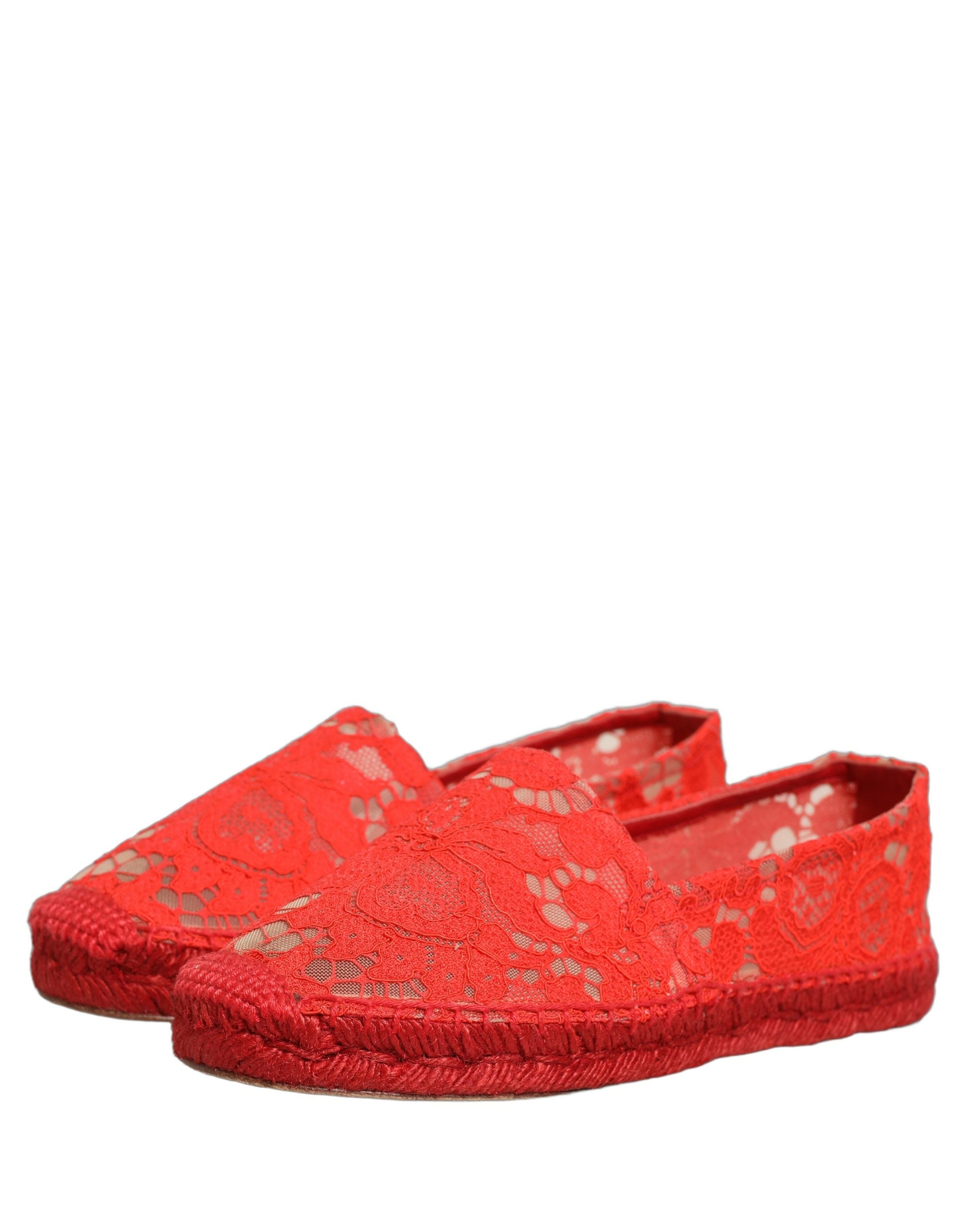 Female model wearing vibrant red floral lace espadrille slip-on shoes with a sheer lace overlay, rope-stitched espadrille sole, and bold red colourway, captured mid-step in a casual lifestyle pose showcasing the shoe's elegant profile and delicate lace detailing.