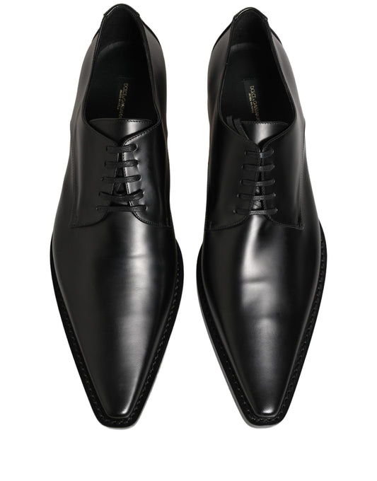 Female model wearing sleek black polished leather Derby shoes with a square toe, clean lace-up front, structured block heel, and high-gloss finish, captured mid-step in a casual lifestyle pose showcasing the shoe's sharp profile and sophisticated silhouette.