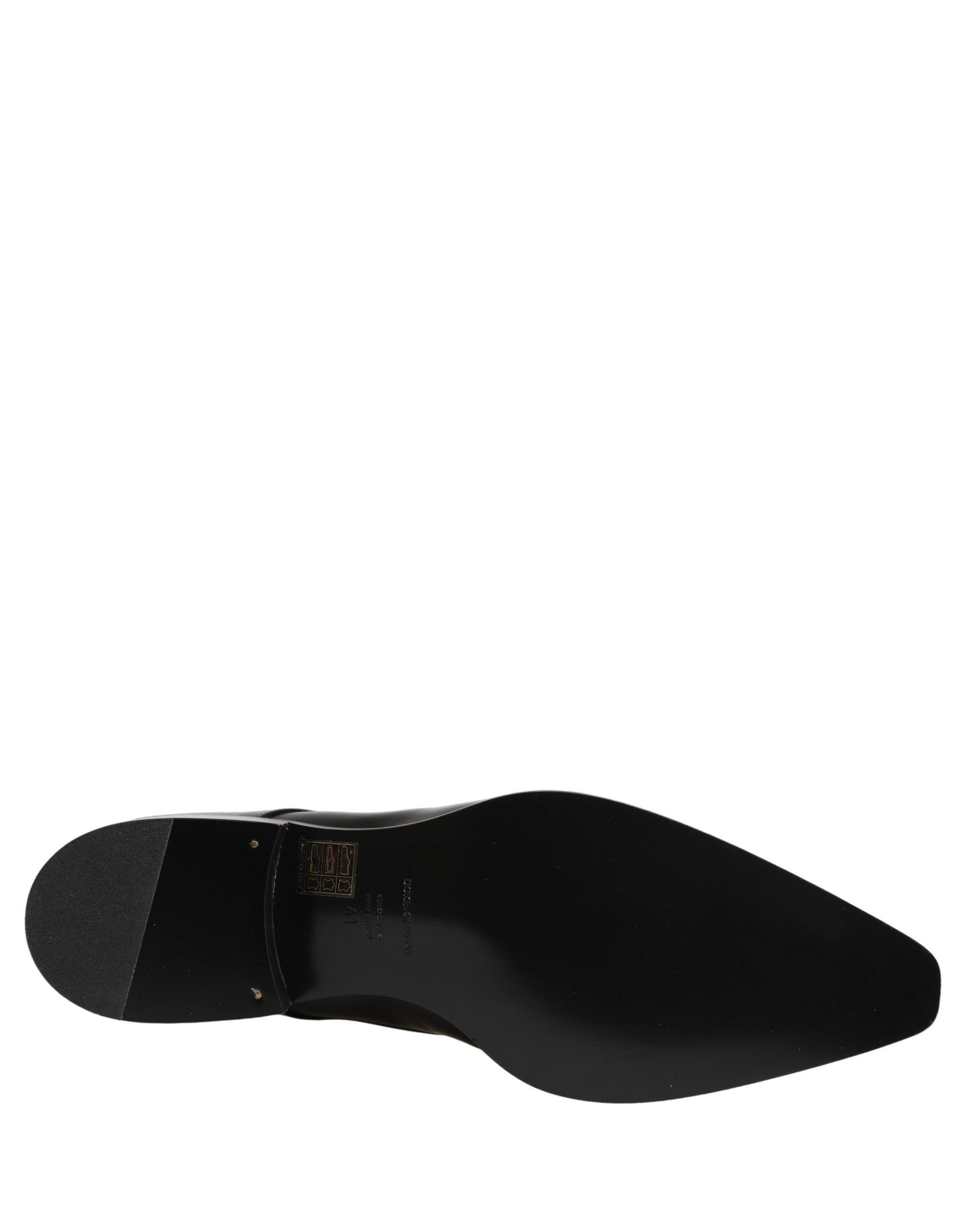 Female model wearing sleek black polished leather Derby shoes with a square toe, clean lace-up front, structured block heel, and high-gloss finish, captured mid-step in a casual lifestyle pose showcasing the shoe's sharp profile and sophisticated silhouette.
