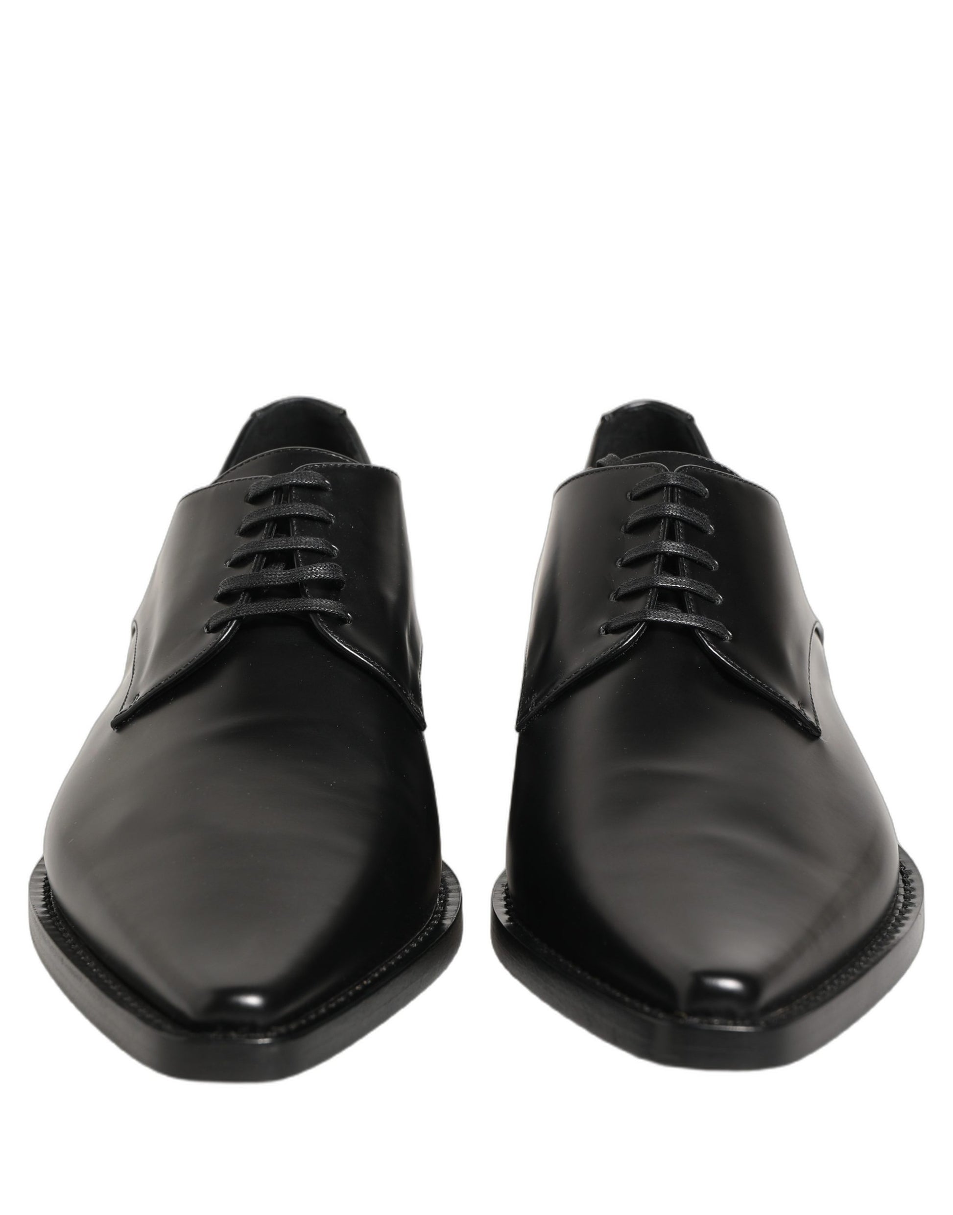 Female model wearing sleek black polished leather Derby shoes with a square toe, clean lace-up front, structured block heel, and high-gloss finish, captured mid-step in a casual lifestyle pose showcasing the shoe's sharp profile and sophisticated silhouette.