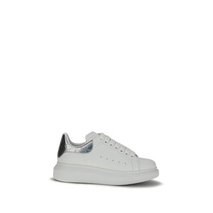 Alexander McQueen white leather platform sneaker with silver metallic heel tab and chunky white sole.