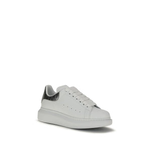 Alexander McQueen white leather platform sneaker with thick white laces and a metallic silver heel tab.