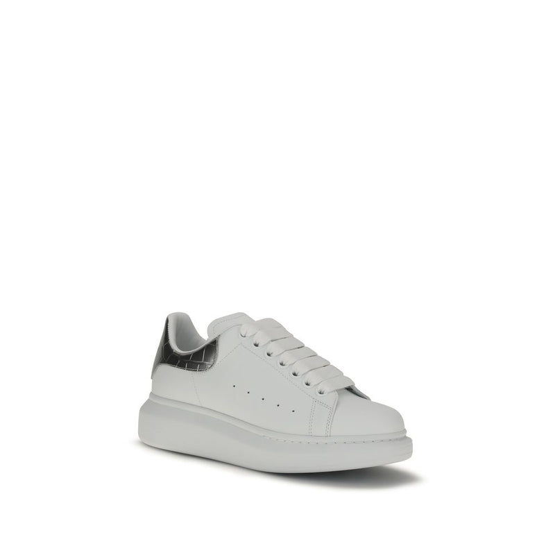 Alexander McQueen white leather platform sneaker with thick white laces and a metallic silver heel tab.