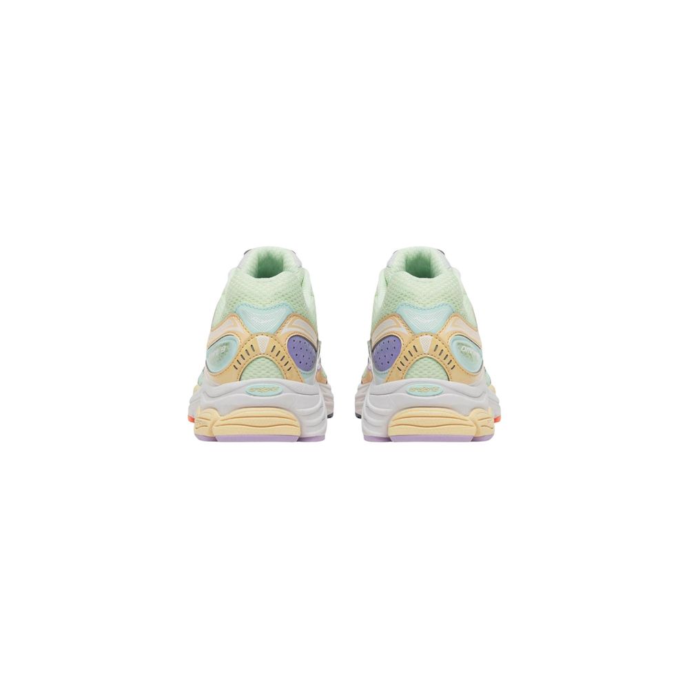Pair of pastel green and yellow sneakers on a white background