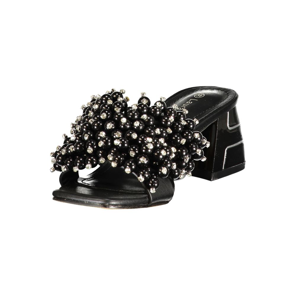 Female model wearing Laura Biagiotti black polyurethane women's sandal with a sleek black upper, elegant strap detailing, and refined Italian craftsmanship, captured mid-step in a casual lifestyle pose showcasing the sandal's bold monochrome sophistication and effortless designer style