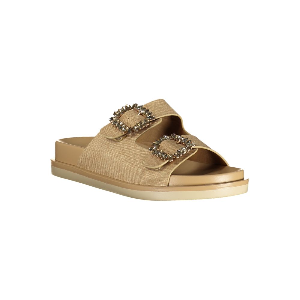 Female model wearing Laura Biagiotti gold polyurethane women's sandal with two wide shimmer straps featuring ornate jewelled buckle embellishments, a cushioned flatform sole, and refined Italian craftsmanship, captured mid-step in a casual lifestyle pose showcasing the sandal's glamorous golden opulence and effortless designer luxury.
