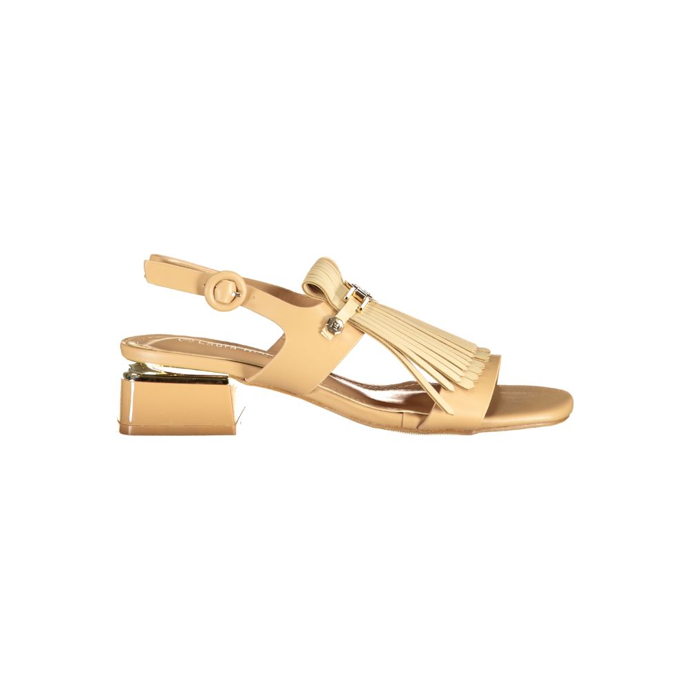 Beige polyurethane women’s sandal with fringe detail, buckle strap, and a gold-accented block heel.