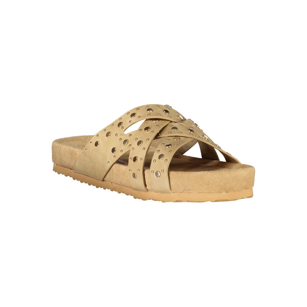 Beige polyurethane women’s slide sandal with a studded, crisscross strap design and a flat footbed.