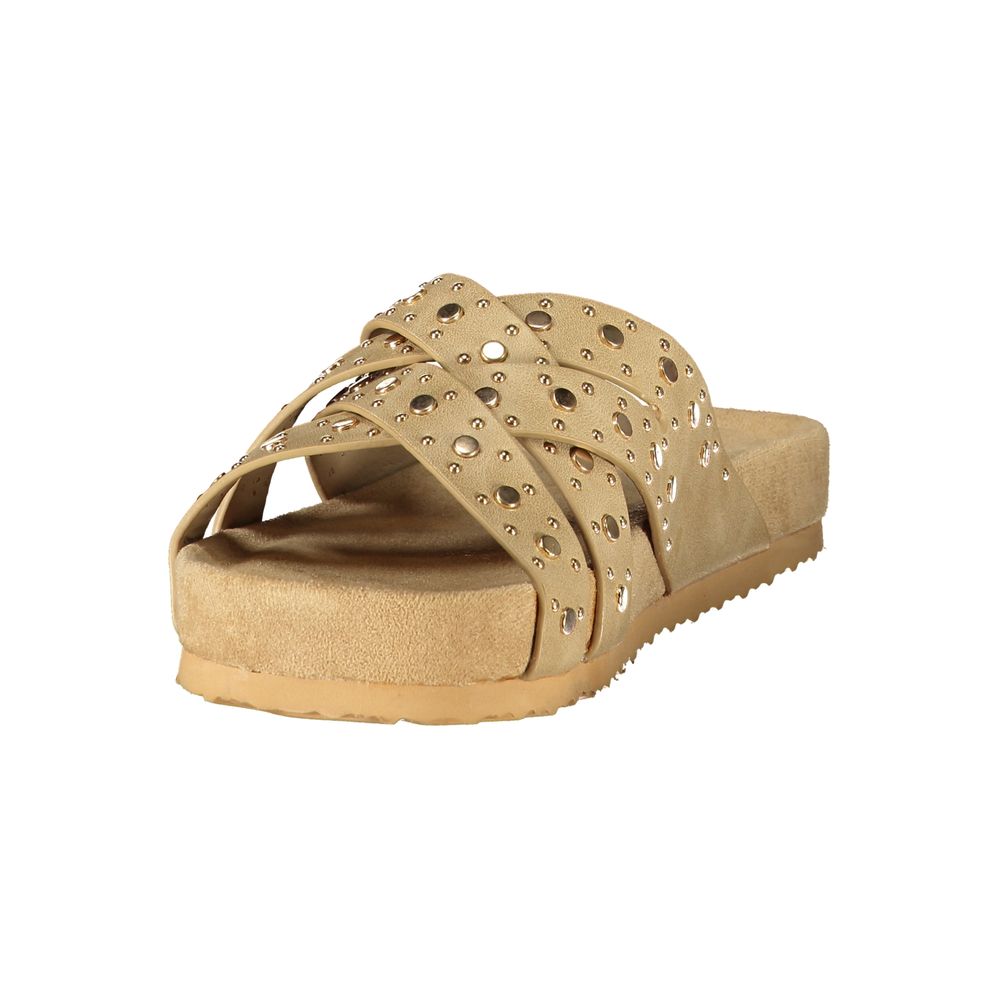 Beige polyurethane women’s slide sandal with crisscross studded straps and a contoured footbed.