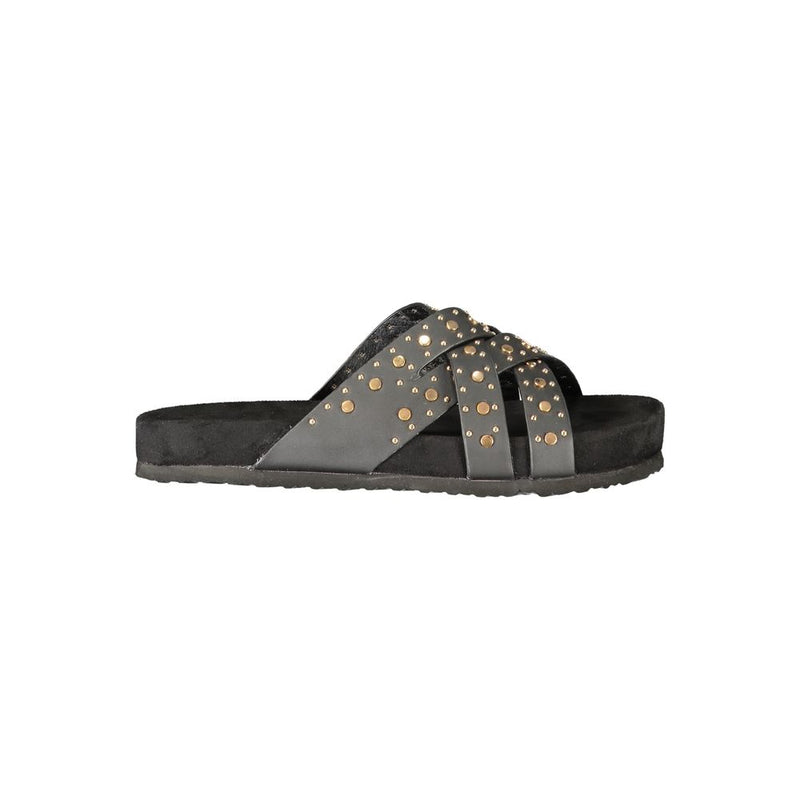 Black polyurethane women's slide sandal with crisscross straps and gold stud embellishments on a flat footbed.