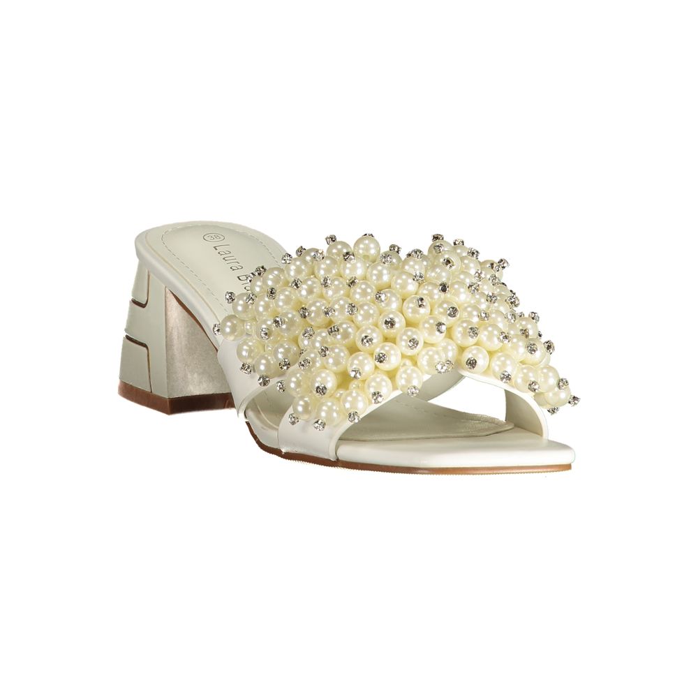 Female model wearing Laura Biagiotti bianco white polyurethane women's sandal with a crisp white upper, elegant strap detailing, and refined Italian craftsmanship, captured mid-step in a casual lifestyle pose showcasing the sandal's clean summer brightness and effortless designer elegance