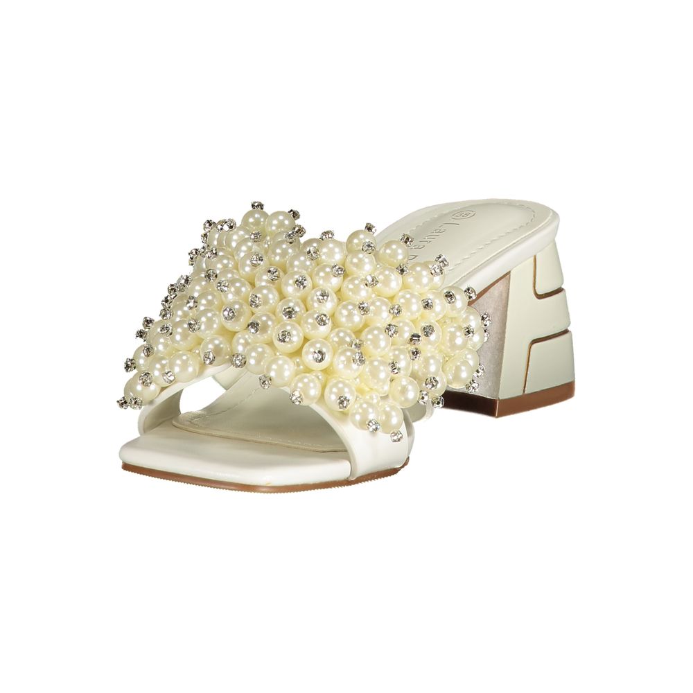 Female model wearing Laura Biagiotti bianco white polyurethane women's sandal with a crisp white upper, elegant strap detailing, and refined Italian craftsmanship, captured mid-step in a casual lifestyle pose showcasing the sandal's clean summer brightness and effortless designer elegance