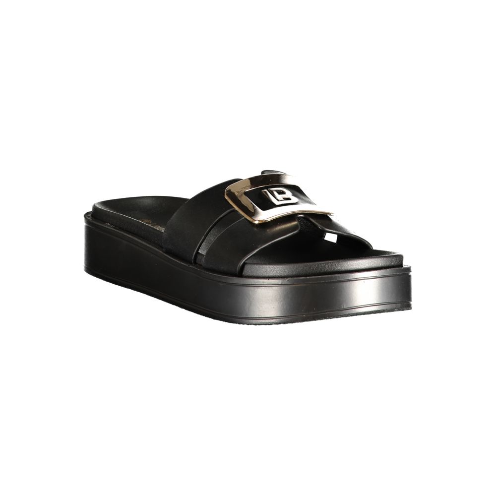 Female model wearing Laura Biagiotti nero black polyurethane women's sandal with a sleek black upper, elegant strap detailing, and refined Italian craftsmanship, captured mid-step in a casual lifestyle pose showcasing the sandal's understated sophistication and effortless designer style
