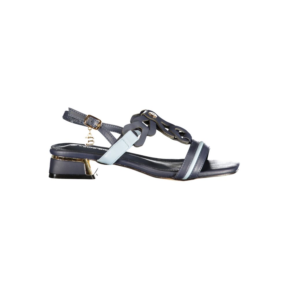 Female model wearing Laura Biagiotti blue polyurethane women's sandal with a vibrant blue upper, elegant strap detailing, and refined Italian craftsmanship, captured mid-step in a casual lifestyle pose showcasing the sandal's bold summer colour and effortless designer sophistication.