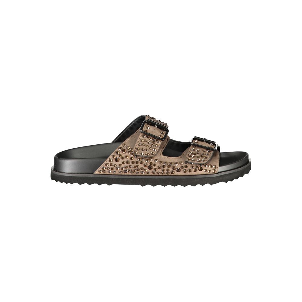Female model wearing Laura Biagiotti brown polyurethane women's slipper with a rich warm brown upper, effortless slip-on silhouette, and refined Italian craftsmanship, captured mid-step in a casual lifestyle pose showcasing the slipper's relaxed luxury and everyday elegance.