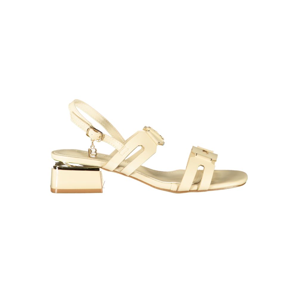 Female model wearing Laura Biagiotti beige polyethylene flat sandals with warm beige straps, lightweight flat construction, and refined Italian detailing, captured mid-step in a casual lifestyle pose showcasing the sandal's understated summer elegance and effortless everyday style.