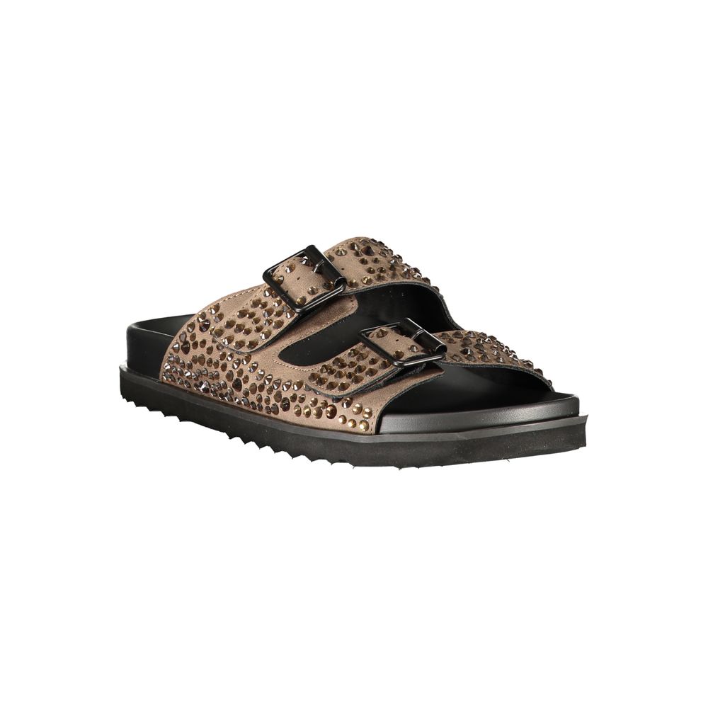 Female model wearing Laura Biagiotti brown polyurethane women's slipper with a rich warm brown upper, effortless slip-on silhouette, and refined Italian craftsmanship, captured mid-step in a casual lifestyle pose showcasing the slipper's relaxed luxury and everyday elegance.