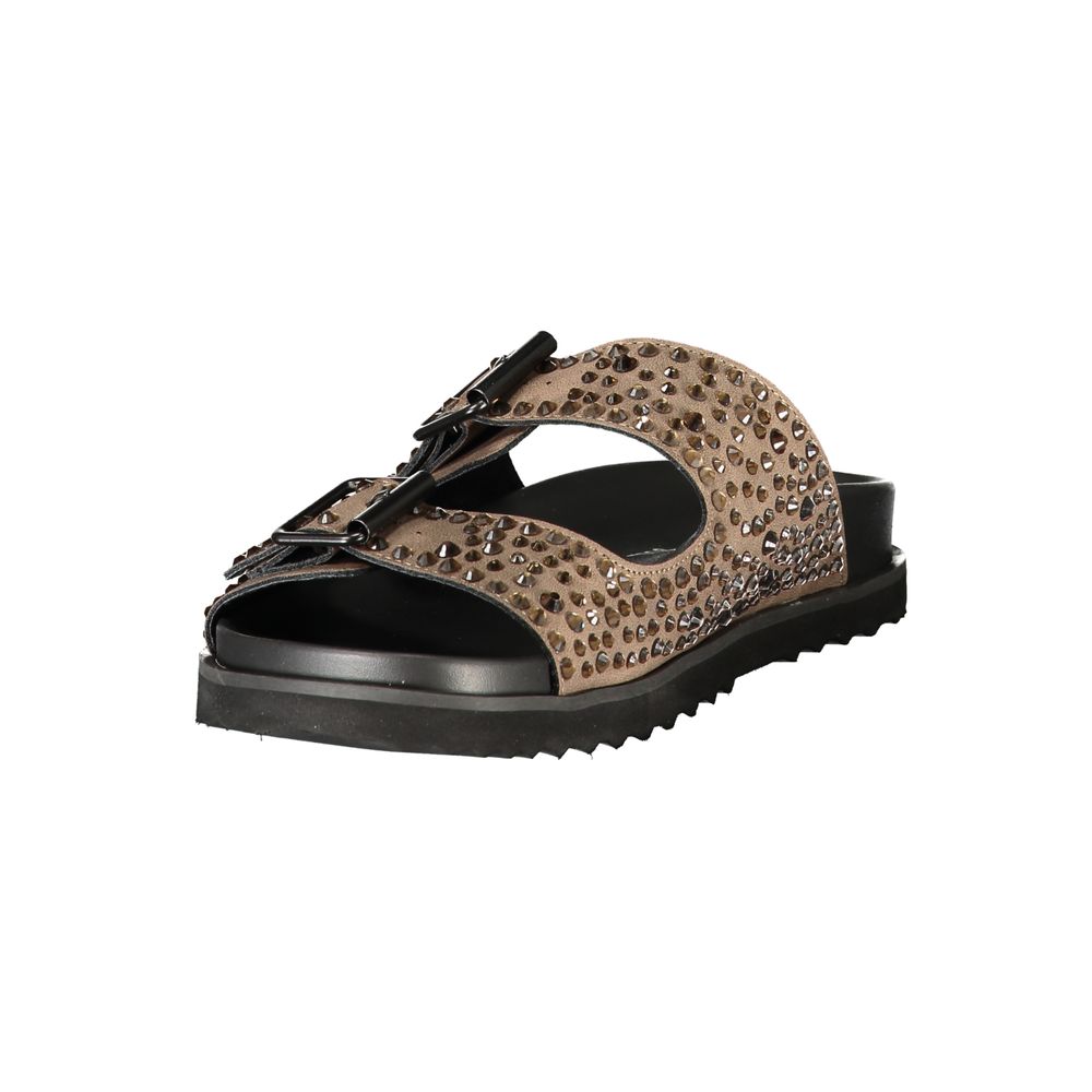 Female model wearing Laura Biagiotti brown polyurethane women's slipper with a rich warm brown upper, effortless slip-on silhouette, and refined Italian craftsmanship, captured mid-step in a casual lifestyle pose showcasing the slipper's relaxed luxury and everyday elegance.