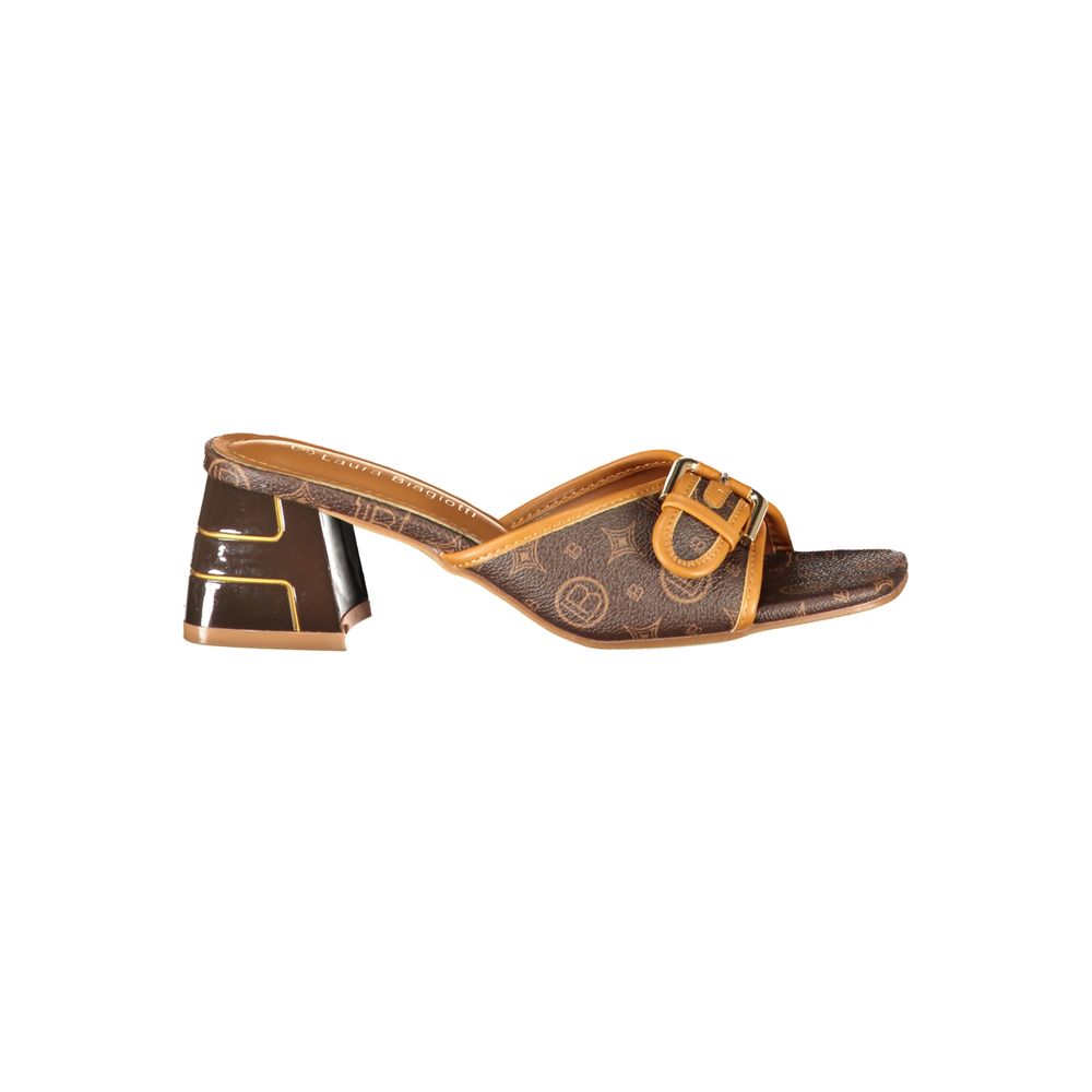 Female model wearing Laura Biagiotti brown polyurethane women's sandal with a warm brown upper, elegant strap detailing, and refined Italian craftsmanship, captured mid-step in a casual lifestyle pose showcasing the sandal's earthy sophistication and effortless summer luxury.