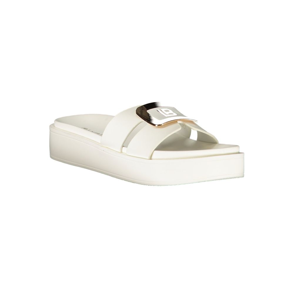 Female model wearing Laura Biagiotti white polyurethane women's sandal with a clean white upper, elegant strap detailing, and refined Italian craftsmanship, captured mid-step in a casual lifestyle pose showcasing the sandal's understated sophistication and effortless summer luxury.