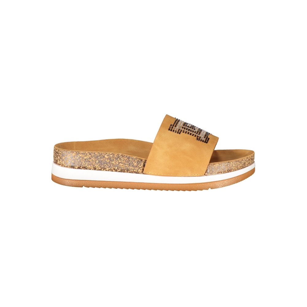 Female model wearing Laura Biagiotti beige polyethylene flip-flop sandals with a warm beige tone, lightweight construction, and refined Italian detailing, captured mid-step in a casual lifestyle pose showcasing the sandal's effortless summer elegance and everyday comfort