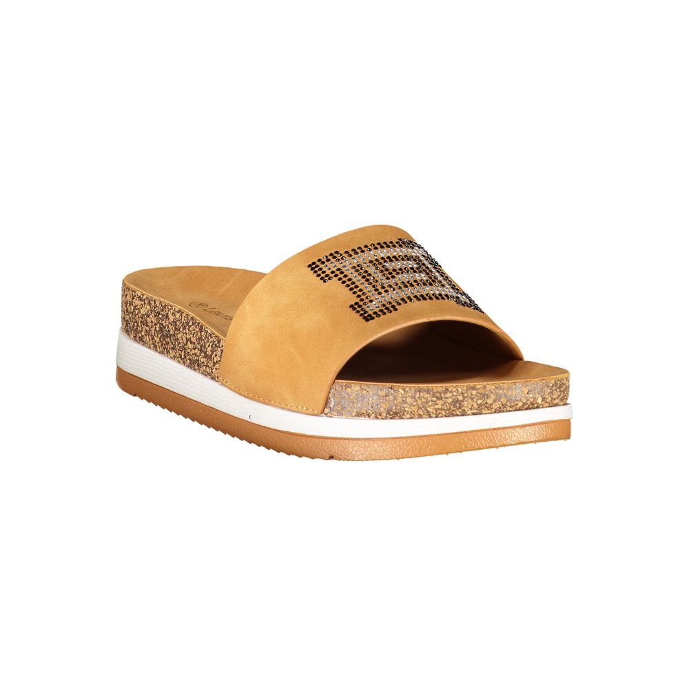 Female model wearing Laura Biagiotti beige polyethylene flip-flop sandals with a warm beige tone, lightweight construction, and refined Italian detailing, captured mid-step in a casual lifestyle pose showcasing the sandal's effortless summer elegance and everyday comfort