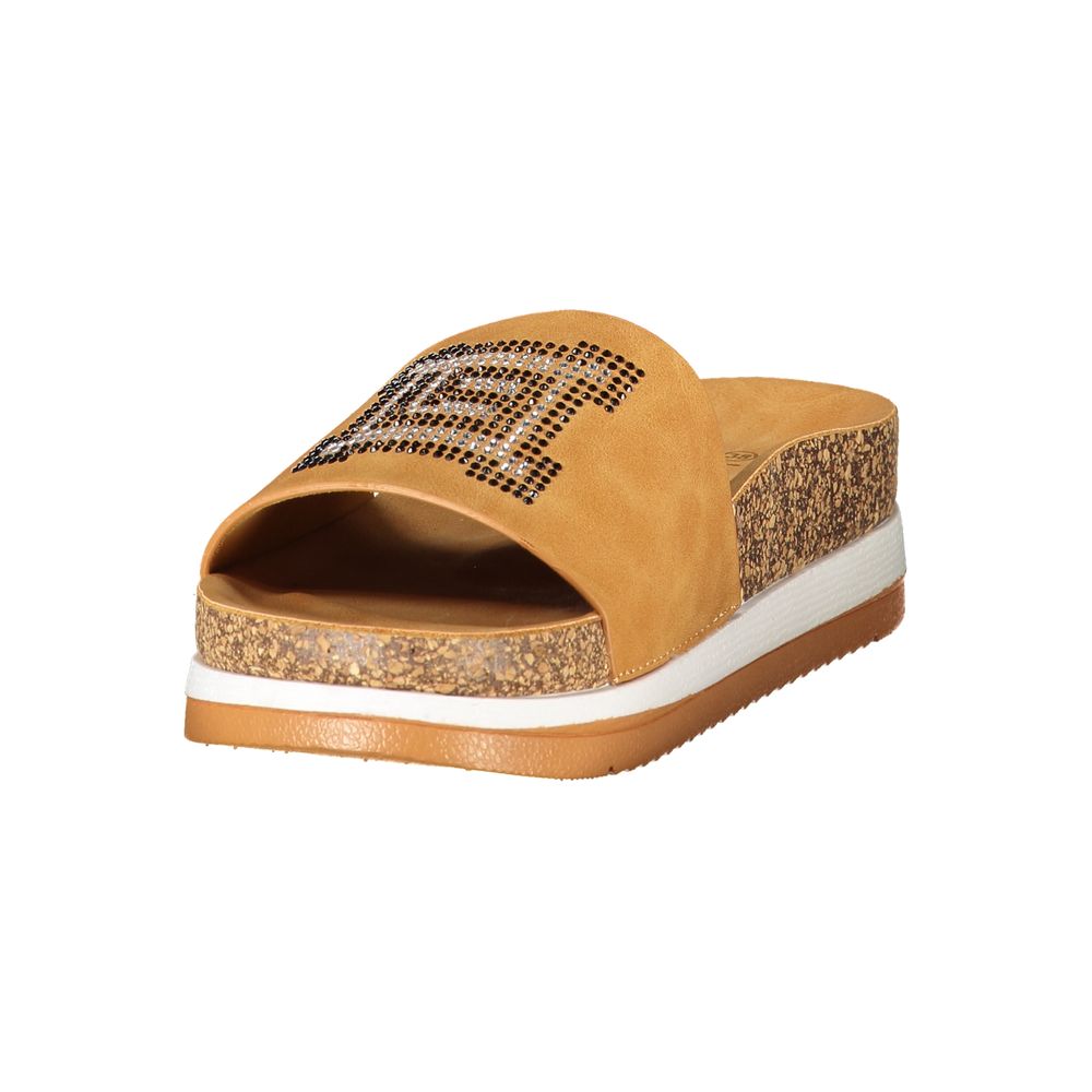 Female model wearing Laura Biagiotti beige polyethylene flip-flop sandals with a warm beige tone, lightweight construction, and refined Italian detailing, captured mid-step in a casual lifestyle pose showcasing the sandal's effortless summer elegance and everyday comfort