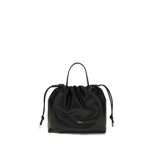 Chloé black lambskin shoulder bag with a gathered drawstring top, top handle, and gold-tone logo.