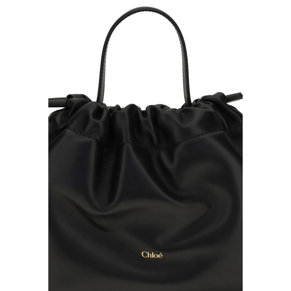 Chloé black lambskin leather shoulder bag with a drawstring top, single strap, and gold-foil logo.