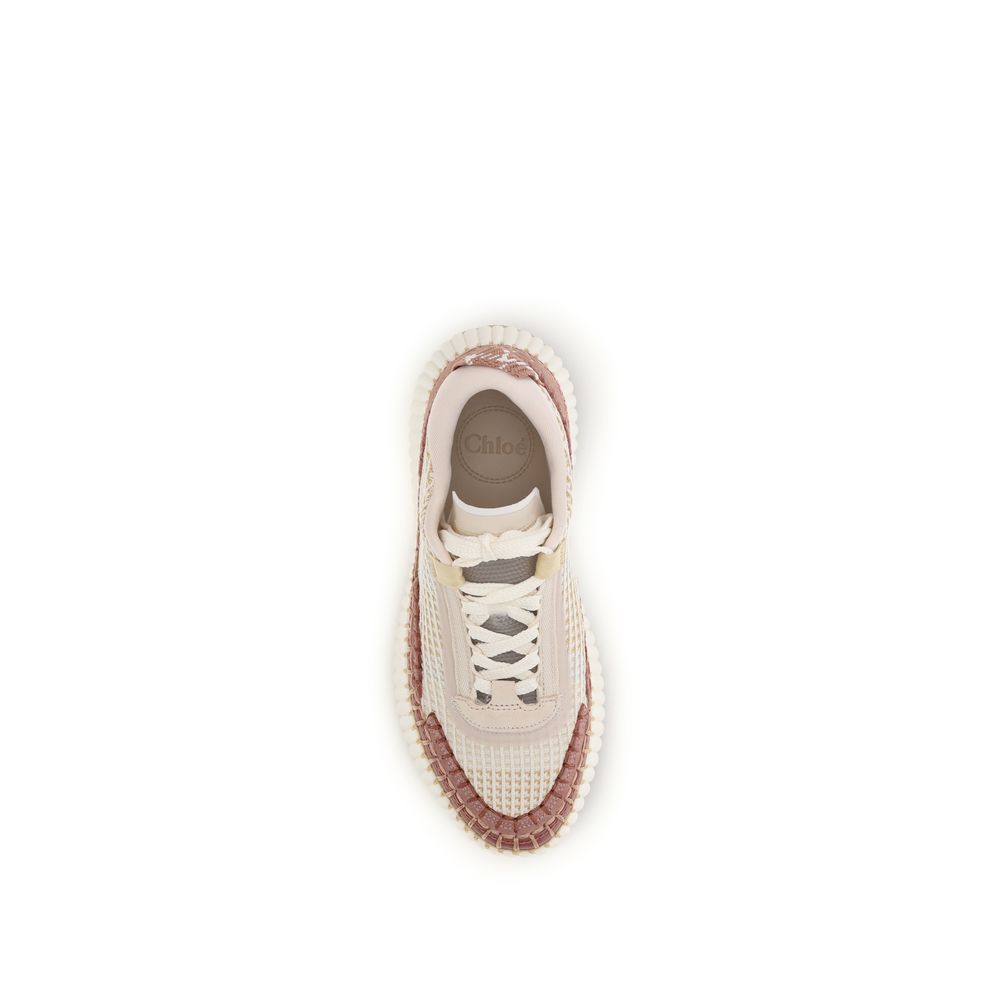 White sneaker with pink accents on a white background