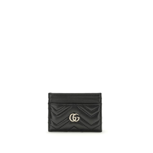 Gucci black leather card wallet with chevron quilting and gold interlocking G logo.