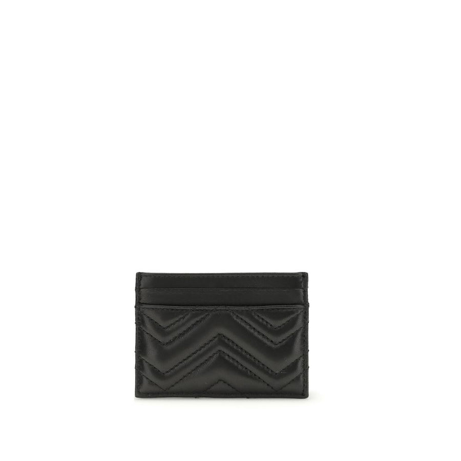 Gucci black leather card wallet with chevron quilting and gold interlocking G logo.