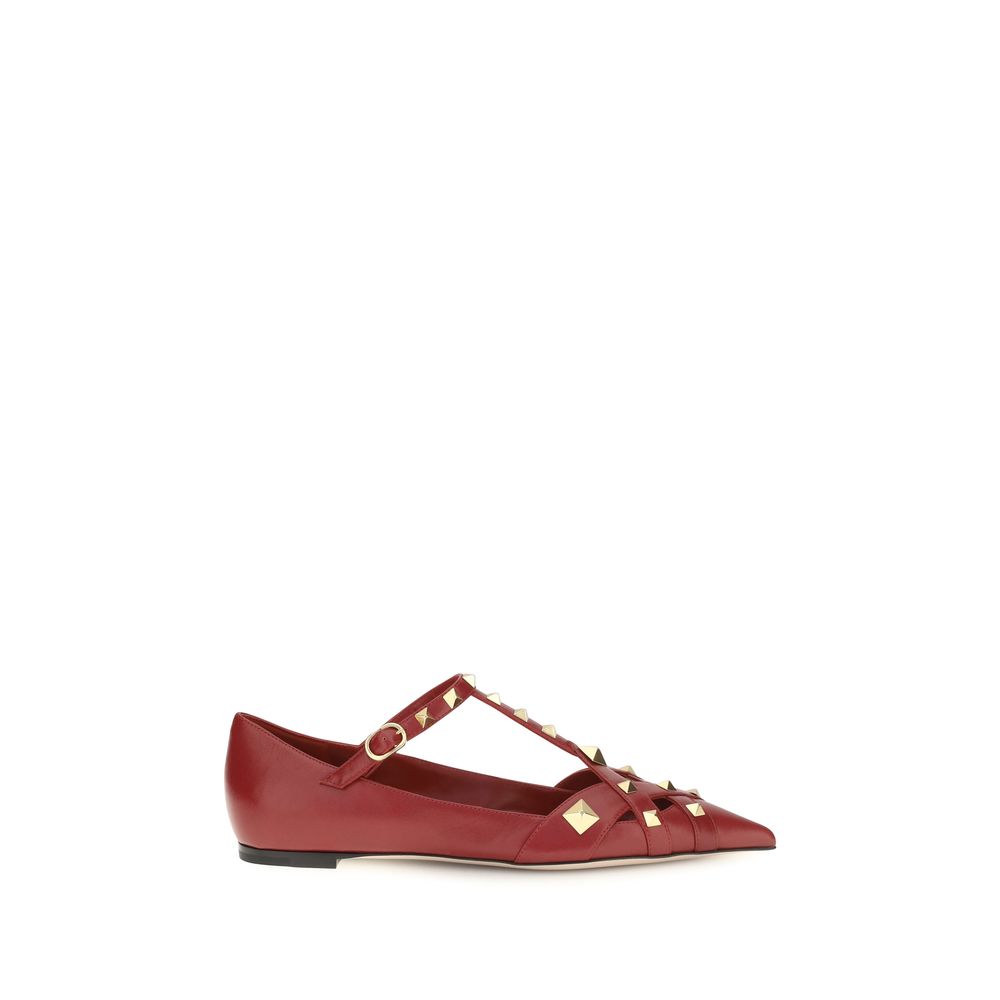 Red flat shoe with gold accents on a white background