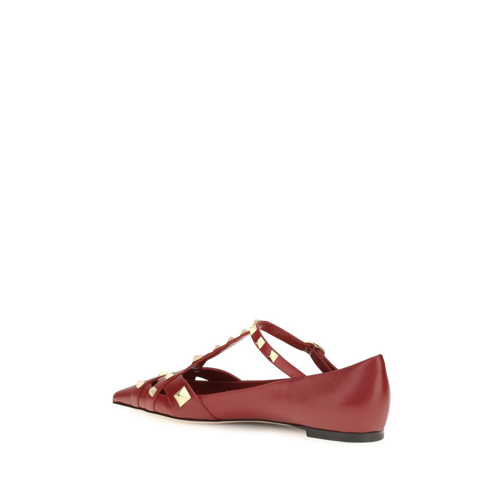 Red flat shoe with gold accents on a white background
