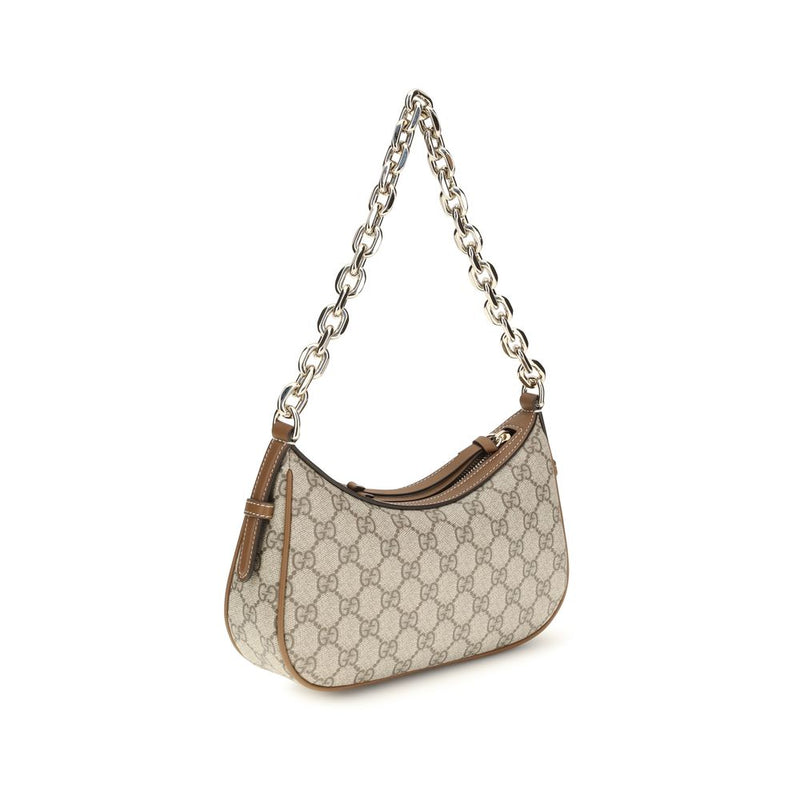 Beige fabric handbag with Gucci monogram, brown leather trim, and a thick chain strap
