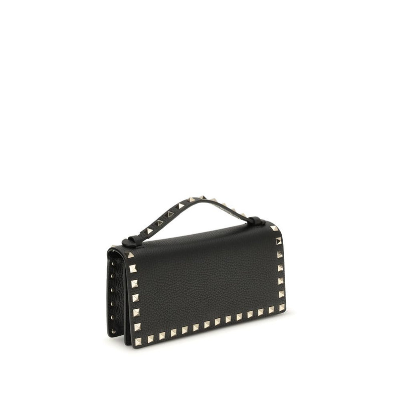 Black leather wallet with gold studs and top handle
