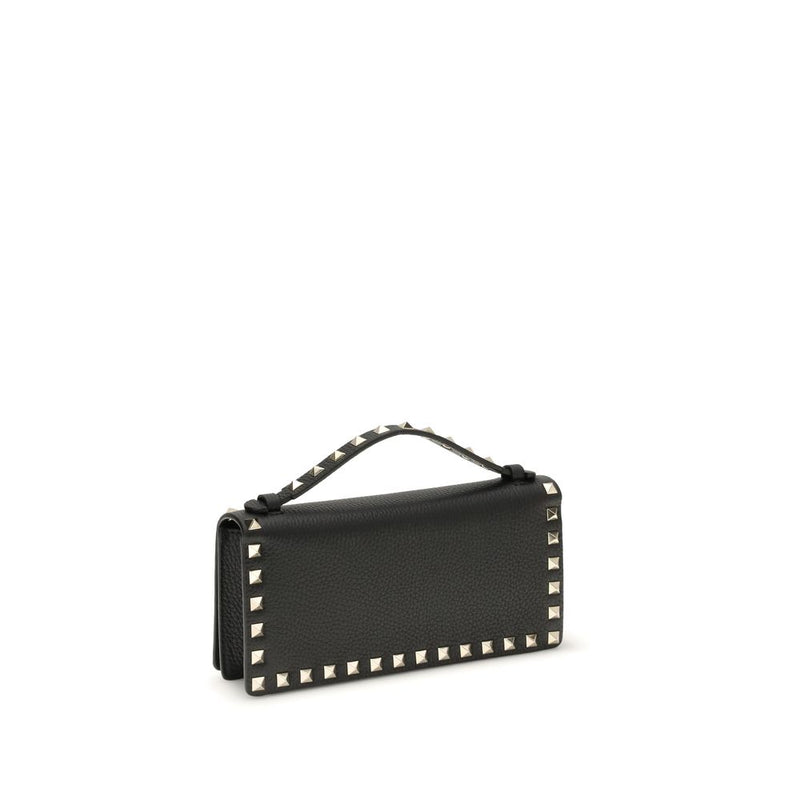 Black leather wallet with a top handle and silver pyramid studs along the edges