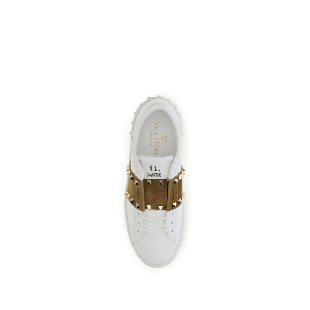 White sneaker with brown studded details on a white background