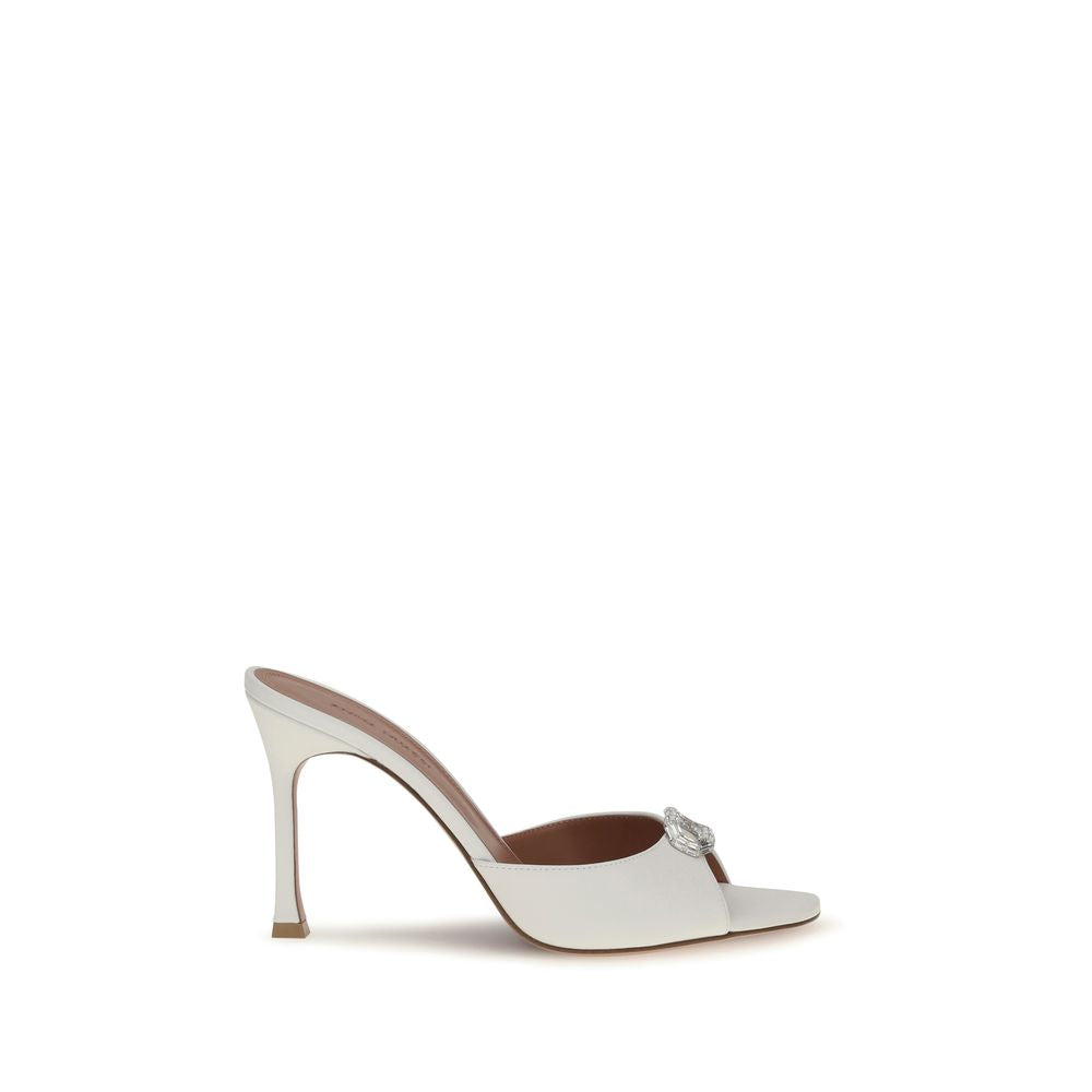 White high-heeled shoe with a decorative buckle on a white background
