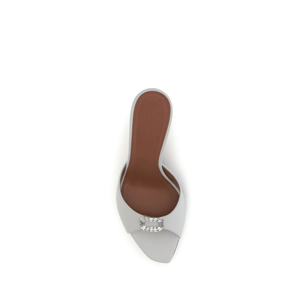 High-heeled shoe with brown insole and silver metallic sole on a white background