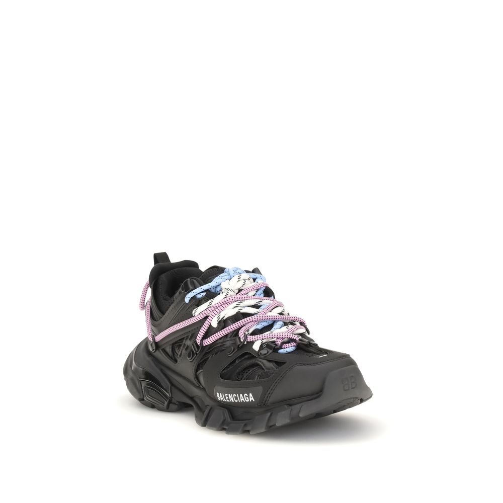 Black sneaker with pink floral laces on a white background