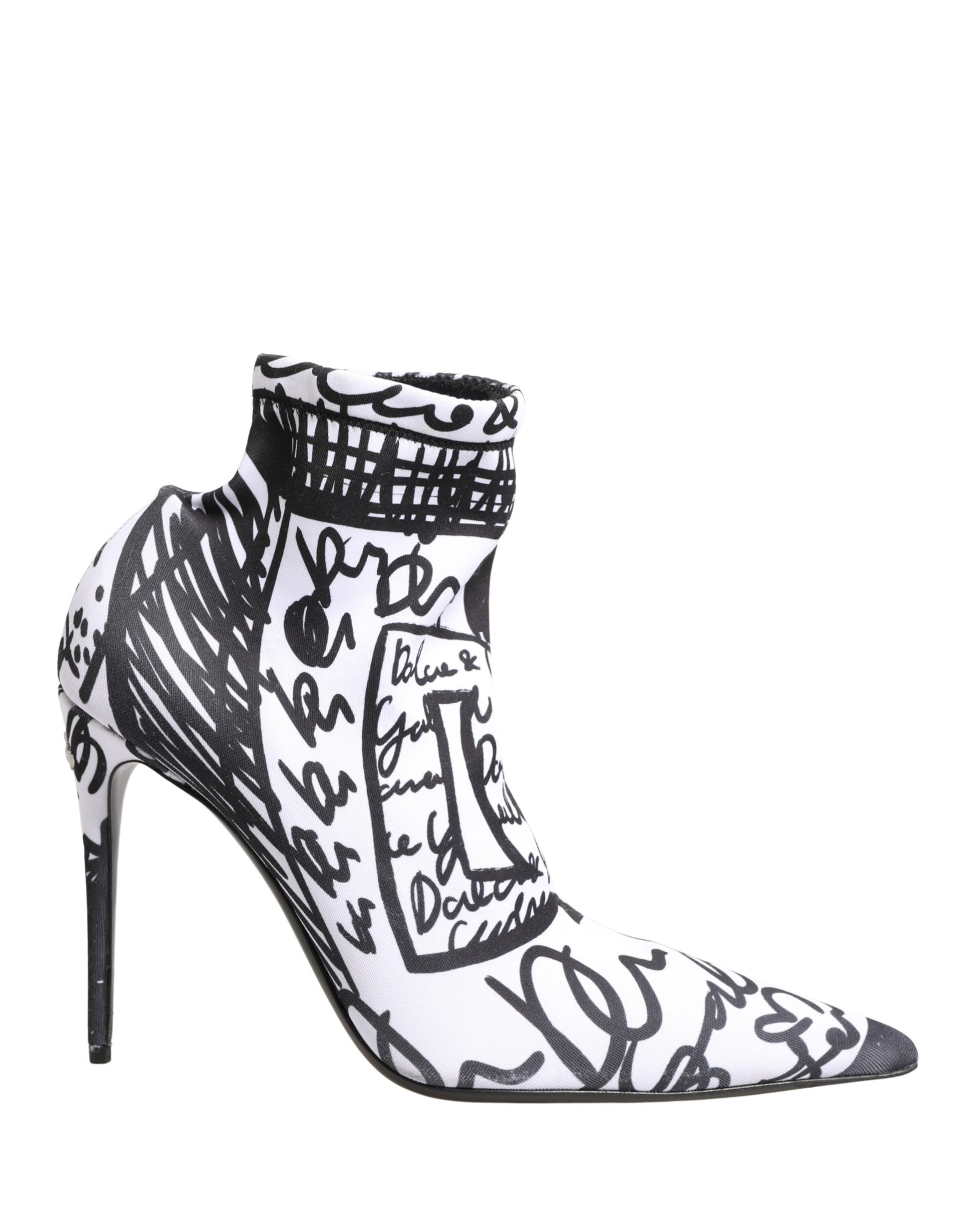 Black and white high-heeled shoes with artistic designs on a white background