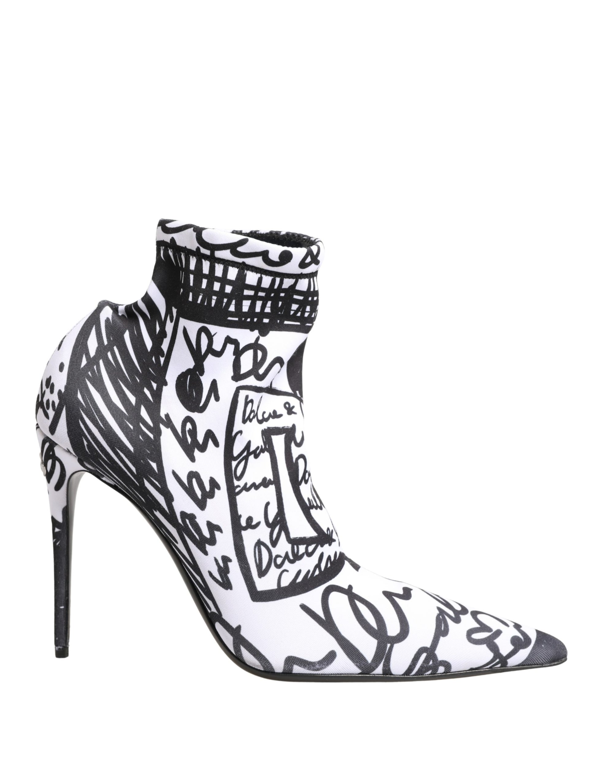 Black and white high-heeled shoes with artistic designs on a white background