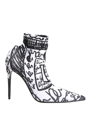 Black and white high-heeled shoes with artistic designs on a white background
