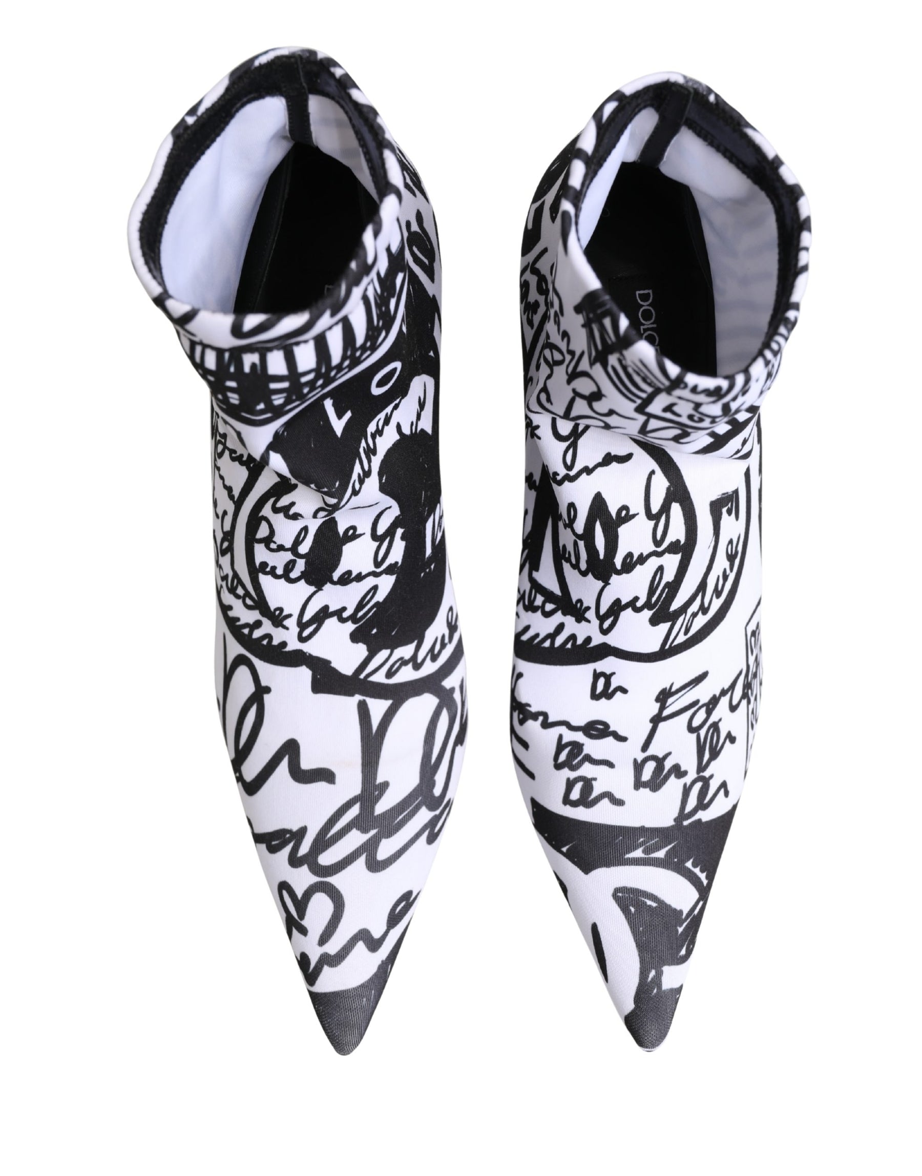 Black and white pointed-toe shoes with artistic designs on a white background