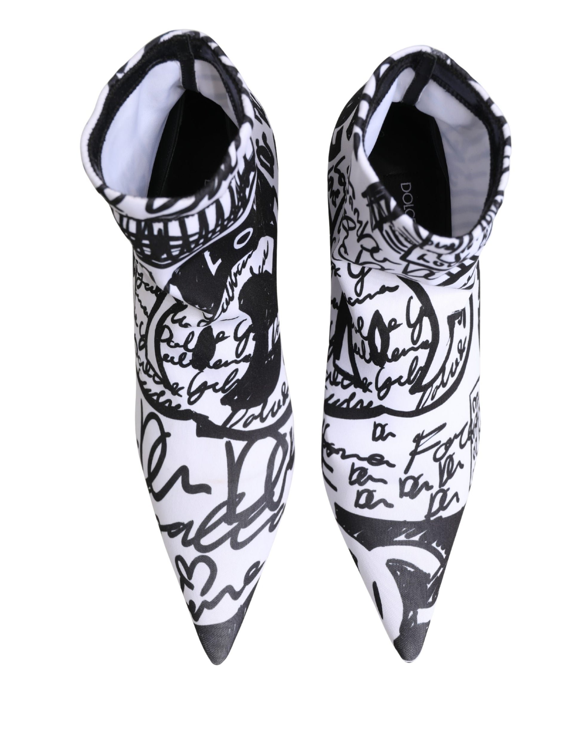 Black and white pointed-toe shoes with artistic designs on a white background