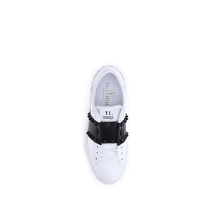 White sneaker with black decorative element on a white background