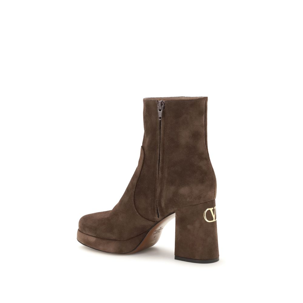 Brown suede platform boot with a brand logo on a white background