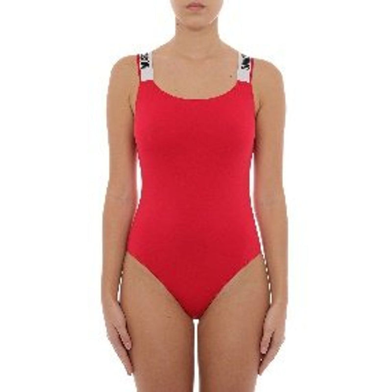 Red cotton one-piece swimsuit with white logo straps worn by a model