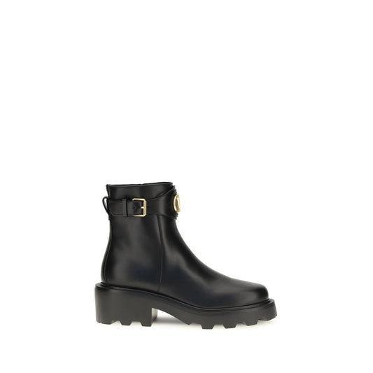 Black rain boot with a gold buckle on a white background